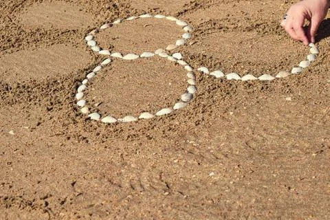 Drawing on a sandy beach. Stock Photos