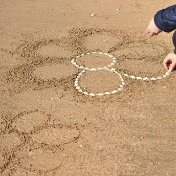 Drawing on a sandy beach. Stock Photos