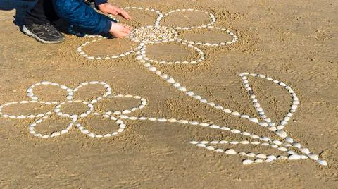 Drawing on a sandy beach. Stock Photos