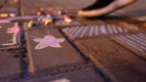 Drawing on the sidewalk with chalk 库存影片 94143638