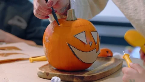 Drawing Smiling Jack O Lantern Face on Pumpkin Stock Footage 342281387