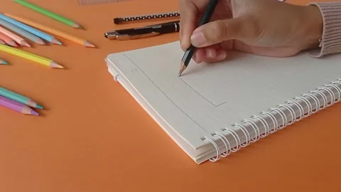 Drawing something on a textbook Stock Footage 150666044