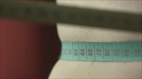 Drawing Tape Measure Tight over the Waistline Stock Footage 60375488