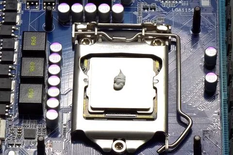 Drawing thermal paste on computer processor. Installing a coolin 写真素材