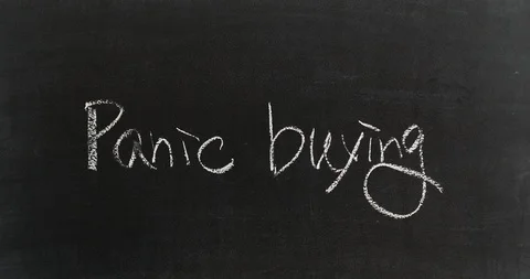 Drawing two lines on "Panic buying" with red chalk on blackboard Stock-Footage 127402080