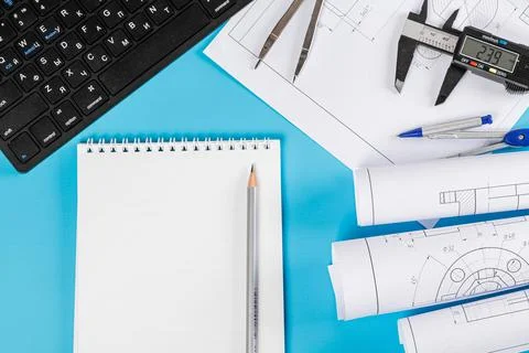 Drawings and project engineering work with keyboard, pencils and notepad on Stock Photos