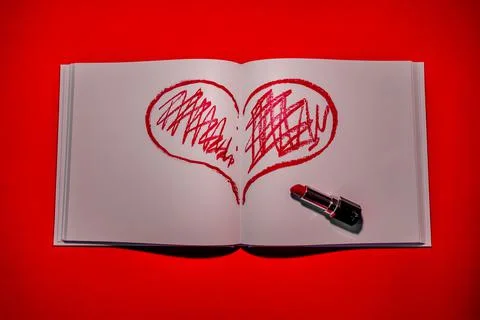 Drawn heart in a notebook on a red background. Happy Valentine's Day. Stock Photos