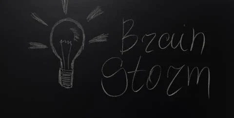Drawn light on blackboard with the text: Brain Storm. Stock Photos