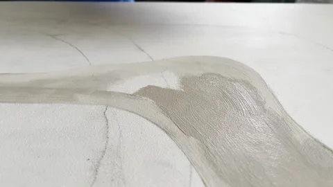 Drawn lines with pencil being painted with beige acrylic paint on canvas, Stock Footage 288454591