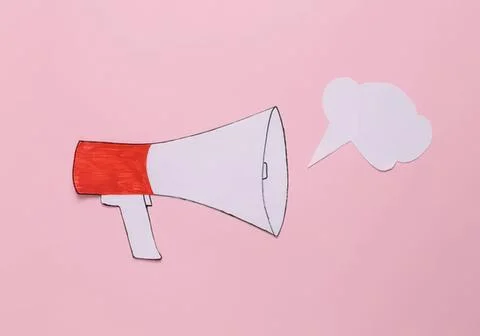 Drawn megaphone with cloud speech bubble on pink background Stock Photos