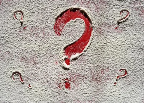Drawn question mark on red background, drawn on flour. Question mark, surprise Stock Photos