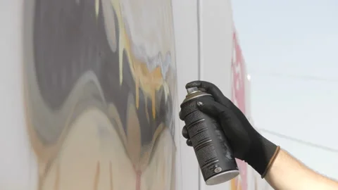 Draws graffiti paint from the container Stock Footage 114294605