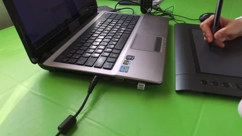Draws on a graphic tablet, with a laptop. Stock Footage 78042646
