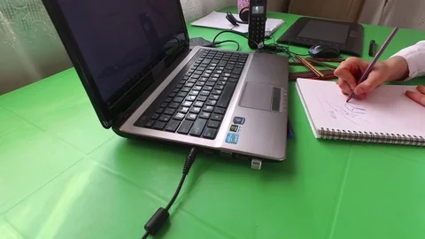 Draws in a notebook with pencils Stock Footage 78043172