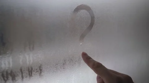 Draws a question mark on the window with your finger. The window was fogged up.  Stock Footage 147041984