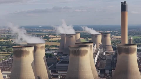 Drax Power Station Cooling Towers Releasing Steam During a Clear Afternoon in Stock Footage 343884688