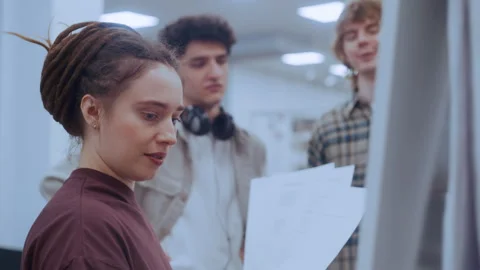 Dreadlocked Female Writing Math on Whiteboard While Curly-Haired Classmates Video stock 335127271