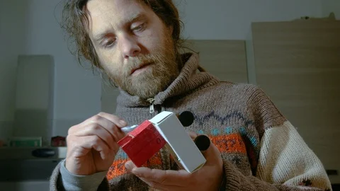 A dreadlocks man builds a recycled machine toys for his son Stock-Footage 87734969