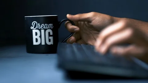 Dream big coffee mug working &amp; drinking 1 Stock Footage 121347360