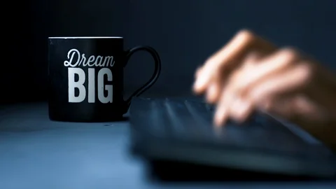 Dream big coffee mug working &amp; drinking Stock Footage 121347463
