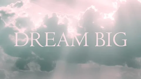Dream big phrase over cloudscape background looped video Stock Footage 317582216