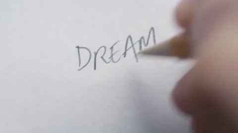 "Dream Big" written on a white sheet of paper with a pencil Stock-Footage 153242956