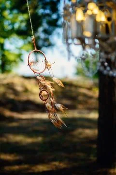 A dream catcher develops in the wind in a forest. Stock Photos