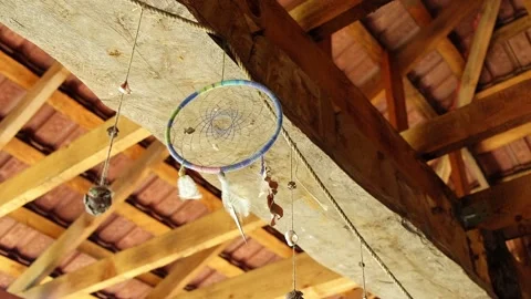 Dream catcher with feathers, threads and beads hangs on rope at entrance to Stock Footage 235597827