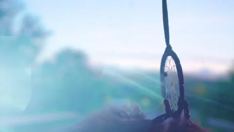 Dream Catcher Hanging From Rear view Mirror Inside Car waving in the wind Video stock 150572873
