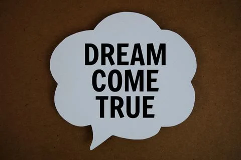 Dream Come True text with speech bubble top view on paper craft background Stock Photos