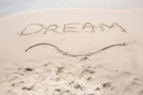 Dream text on sand at beach Stock-Fotos