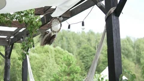Dreamcatcher sways in the wind on the veranda in summer Stock Footage 113048332