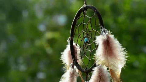 Dreamcatcher turning in front of blurring trees Stockbeeldmateriaal 11711166