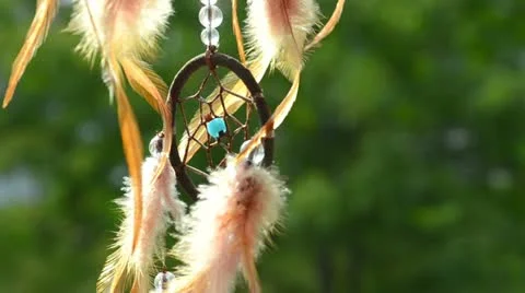 Dreamcatcher turning in front of blurring trees (text space) Stock Footage 11725762