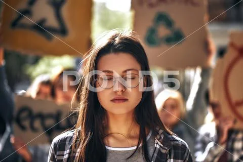 Dreaming about clean earth. Young woman in eyewear keeping eyes closed while Stock Photos
