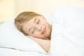 The dreaming girl lay on the bed Photo