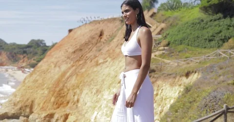 Dreaming model in white on landscape Stock Footage