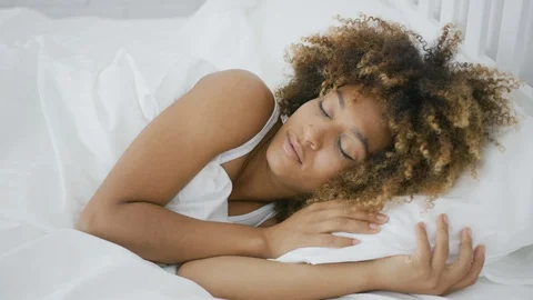 Dreaming woman sleeping in bed Stock Footage