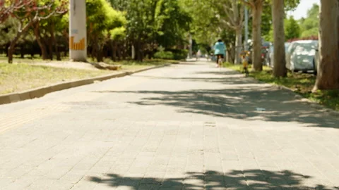 Dreamlike back of a cyclist in the shade of a tree on a summer afternoon 動画素材 273676254