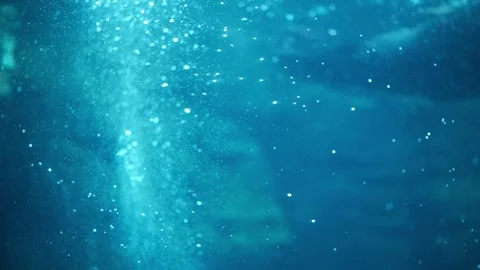 A dreamy, blue scene as air bubbles rise through blue water, reflecting lights Stock Footage 331158641