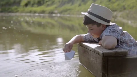 Dreamy boy in an old boat Stock Footage 76168075