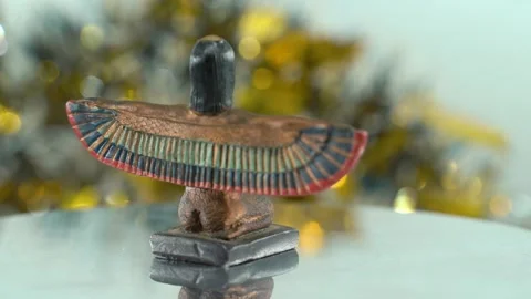 Dreamy close-up shot of a Cleopatra statue with wide open wings, shiny Stock Footage 259639018