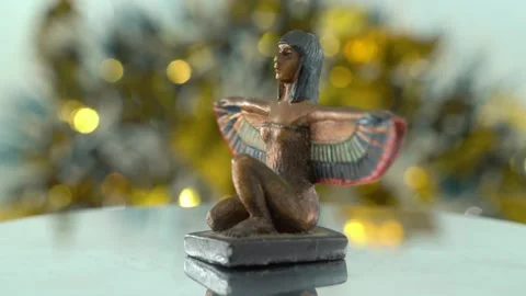 Dreamy close-up shot of a Cleopatra statue with wide open bird wings, Stock Footage 259834665