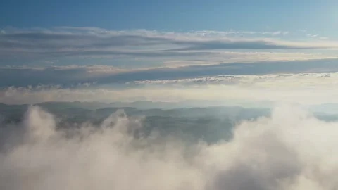 Dreamy clouds with landscape blue sky yellow sun light drone shot Inspire2 Stock Footage 252498704