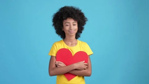 Dreamy kid cuddle red card heart romantic gift isolated blue color background Video stock 169238339