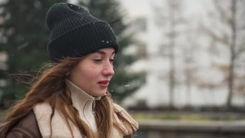 Dreamy Lady in Brown Shearling Jacket During Light Snowfall and Gentle Wind Stock Footage 305562779
