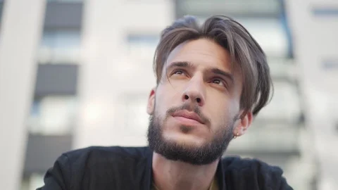 Dreamy man looking up in wind Stock Footage 113696706
