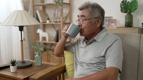 Dreamy old senior middle aged man sit on sofa Stock Footage 165755906