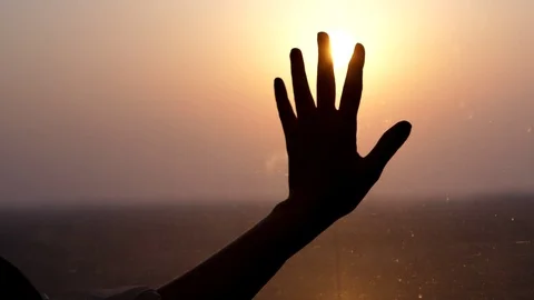 Dreamy passenger put hand on train window, against shining sun Stock Footage 104310417