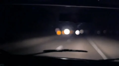 Dreamy POV shot driving traveling down dark highway at night in slow motion Stock Footage